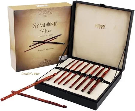 The image shows an open box of Symfonie Rose Crochet Hook Set from Knitter's Pride. The box contains several wooden crochet hooks arranged neatly in a padded interior. The product packaging is visible, displaying the brand name and product details.