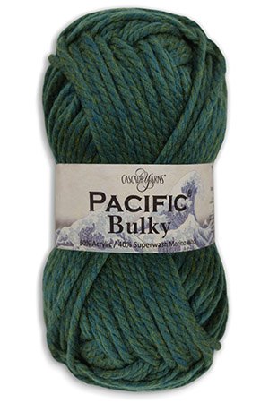 A skein of Pacific Bulky yarn is displayed. The yarn is a blend of 60% acrylic and 40% superwash merino, and it is colored in a blue-green hue. The label is wrapped around the yarn, featuring the brand name Universal Yarn.
