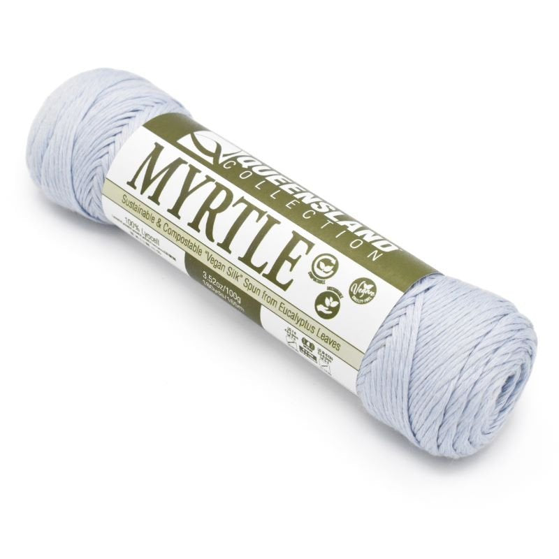 A skein of Queensland Collection Myrtle yarn in a light blue color. The label indicates it is sustainable and compostable vegan silk spun from eucalyptus leaves, weighing 100g and measuring 175m in length.