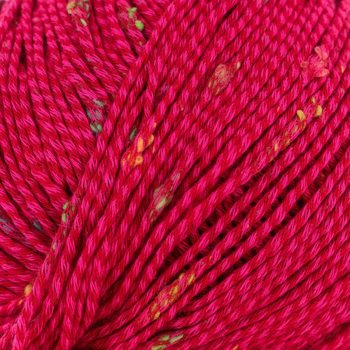 Close-up of bright pink yarn with small multicolored specks woven into it. The yarn is tightly wound, showcasing its texture and details.