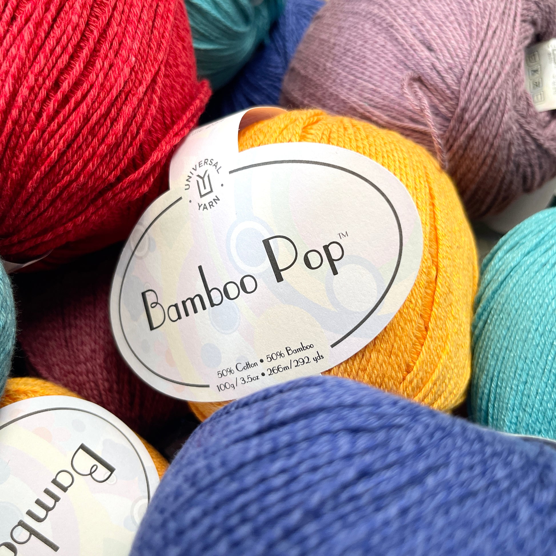 Balls of colorful yarn with 'Bamboo Pop' labels.