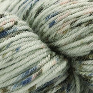 A skein of multicolored yarn labeled "Heritage 6" is shown. The yarn has varying shades of red, pink, and white. The label indicates that it is made of 75% Superwash Merino Wool and 25% Nylon.