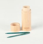 A cylindrical wooden case with a removable lid stands on a white background. Next to it, there are two green knitting needles. The word "Knitters" is etched near the base of the case.