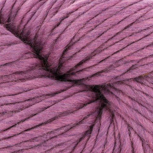 Close-up view of a skein of thick, pink yarn. The fibers are densely packed and showcase a soft, plush texture. The yarn appears to be ideal for knitting or crocheting projects that require a bulkier material.