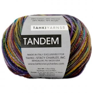 A multi-colored ball of yarn with a label that reads "TAHKI YARNS TANDEM." The label indicates the yarn is made of 28% cotton, 28% viscose, 28% nylon, and 16% acrylic. It is made in Italy exclusively for Tahki - Stacy Charles, Inc. in Bensalem, PA, USA.