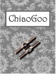 A close-up image of a ChiaoGoo knitting needle packaging. The background is a gray color with white, intricate lace patterns. In the center, there are two ChiaoGoo knitting accessories displayed horizontally.