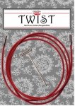 A package of red TWIST brand lace knitting needles is shown. The set includes a red flexible cable and a small metal tool, all placed on a gray and white patterned background.