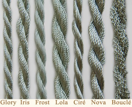 Seven strands of different braided textures of the same silver-colored yarn are laid vertically next to each other. Each strand is labeled below from left to right: Glory, Iris, Frost, Lola, Ciré, Nova, Bouclé.