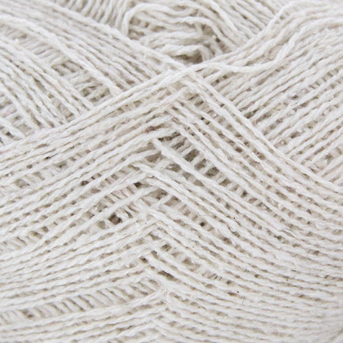 A ball of Berroco Remix Light yarn with a label indicating it is made of 100% recycled fibers. The yarn is light gray.